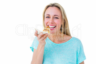 Smiling blonde eating slice of pizza