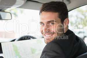 Young businessman reading a map