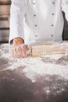 Close up of baker using a rolling pin