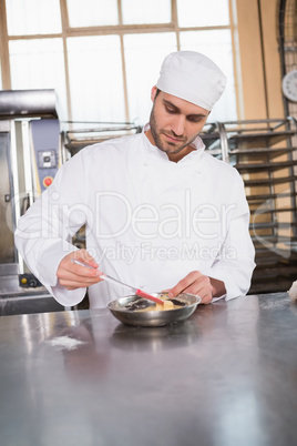 Focused baker preparing a pastry