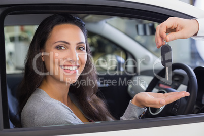 Salesman giving keys to a smiling woman