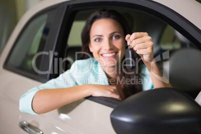 Smiling woman holding car key