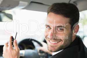 Young businessman smiling at camera