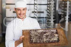 Baker showing freshly baked brownie