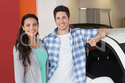 Smiling couple holding their new car key