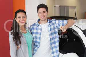 Smiling couple holding their new car key