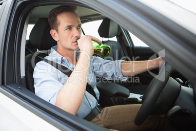 Man drinking beer while driving