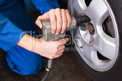 Mechanic adjusting the tire wheel