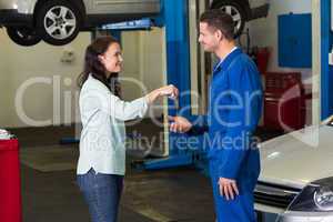 Customer giving her car keys to mechanic
