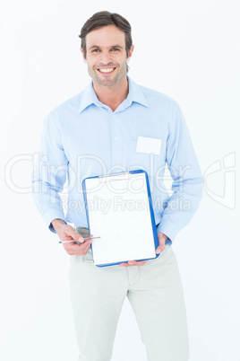 Happy businessman showing blank clipboard