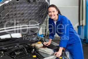 Mechanic examining under hood of car