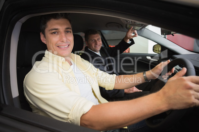 Businessman pointing a car interior