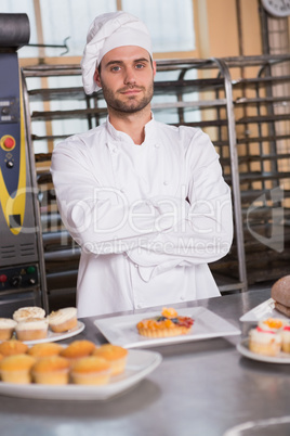 Portrait of smiling worker behind the dessert