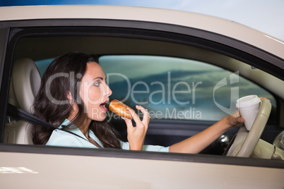 Woman drinking coffee and eating donnut