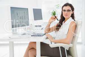 Pretty businesswoman using digitizer at desk