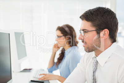 Business colleagues with glasses using computer