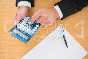 Businessman working on his finances at his desk