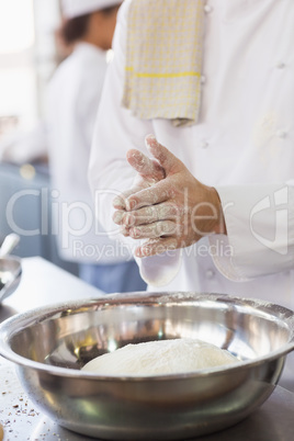 Baker clapping flour from his hands