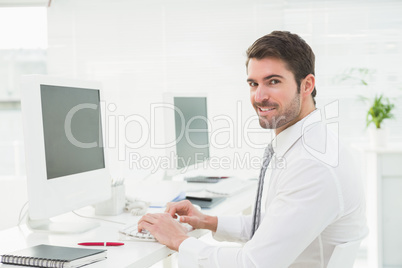 Elegant businessman typing on keyboard