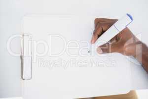 Hand of businessman writing on notepad with marker