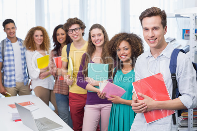 Students smiling at camera standing in a line