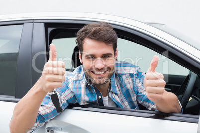 Young man smiling and showing thumbs up