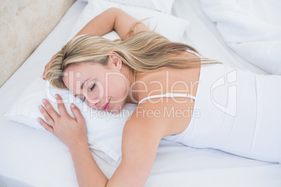 Relaxed blonde woman sleeping in bed