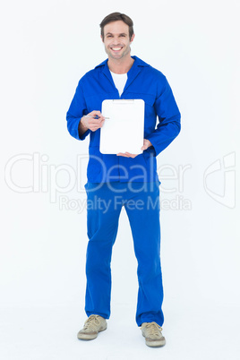 Confident mechanic showing blank clipboard