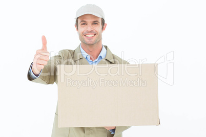 Happy delivery man gesturing thumbs up while carrying cardboard Happy delivery man gesturing thumbs up while carrying cardboard