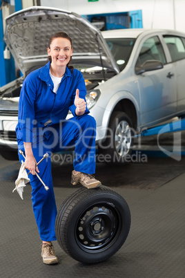Mechanic leaning on a tire wheel
