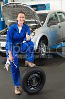 Mechanic leaning on a tire wheel