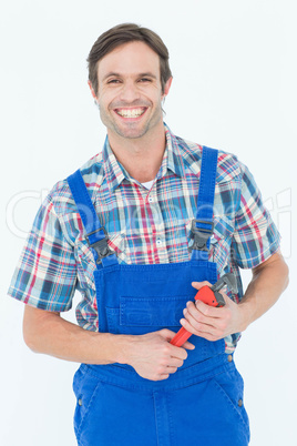 Confident plumber holding monkey wrench