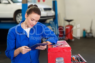 Mechanic using her tablet pc