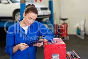 Mechanic using her tablet pc