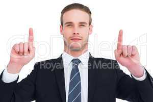 Serious businessman pointing up his fingers