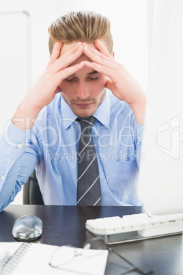 Tired businessman with his hands on face