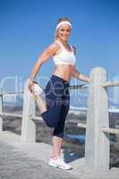 Fit blonde stretching on the pier