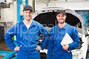 Team of mechanics smiling at camera