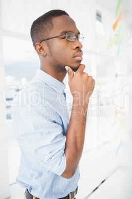 Serious businessman thinking with hand on chin