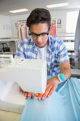 Concentrated university student sewing