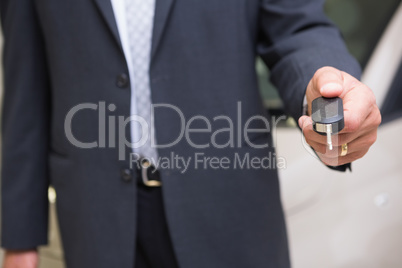 Close up of salesman givng a customer car keys