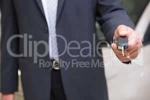 Close up of salesman givng a customer car keys