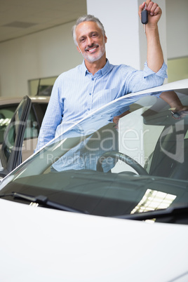 Smiling man holding car key