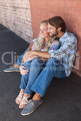 Cute couple sitting on ground