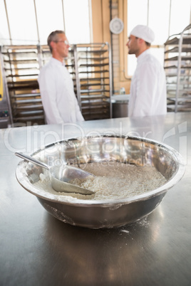 Close up of mixing bowls and scoops on flour