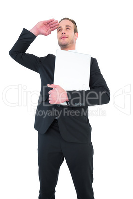 Smiling businessman looking and holding laptop