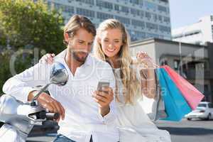 Attractive couple riding a scooter