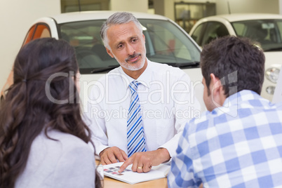 Salesperson pointing something on booklet