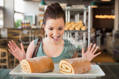 Pretty brunette looking at swiss roll