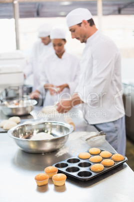 Team of bakers working at counter